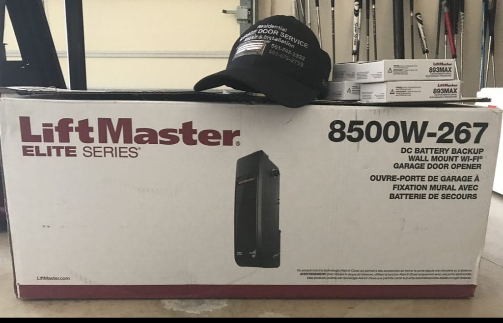LiftMaster 8500W-267 garage door opener box with a black RGDS Residential Garage Door Service cap resting on top.