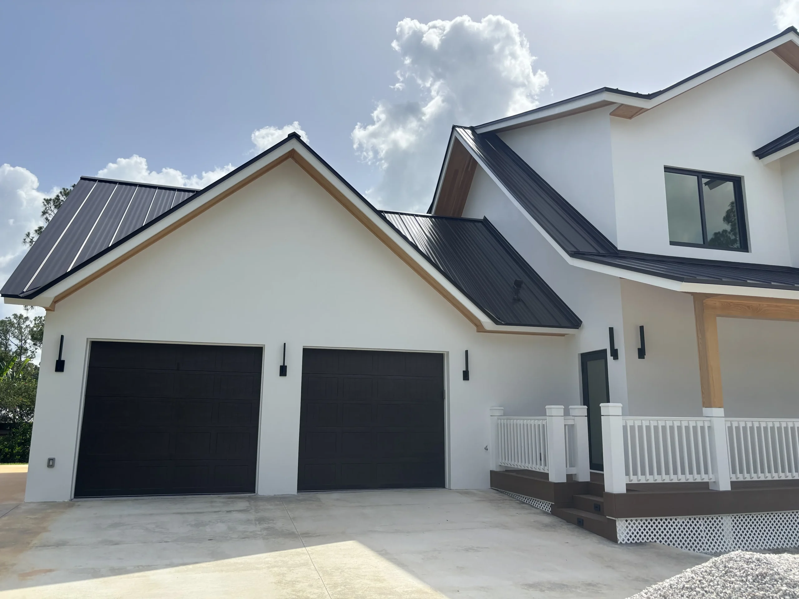 Technician performing Garage Door Installation & Replacement on garage door system in home.