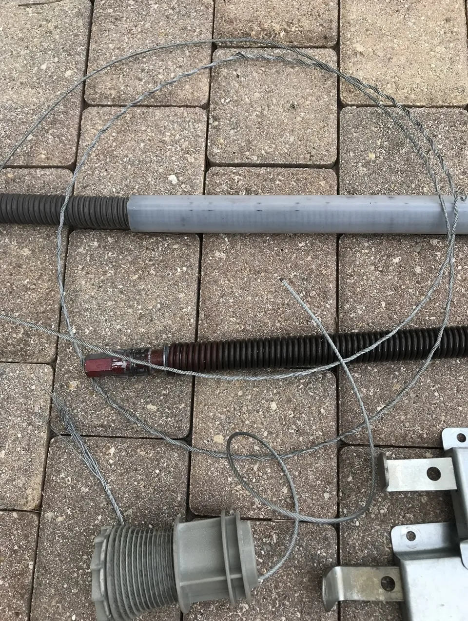 Damaged cable drum showing signs of failure, emphasizing safety risks associated with broken garage door cables