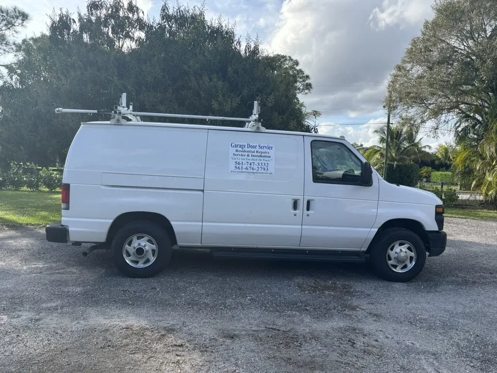 Garage door technician arriving at a customer's home, showcasing RGDS branding and professional service