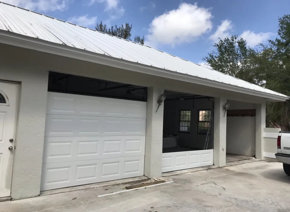 Triple garage doors mid-replacement with a domino effect — each door section shows a different amount of panels installed